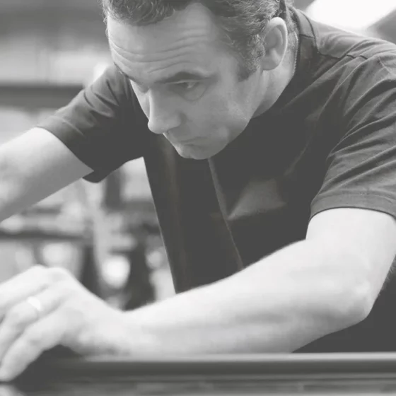 image en noir et blanc d'un ouvrier fabriquant des caves à vin dans usine artevino